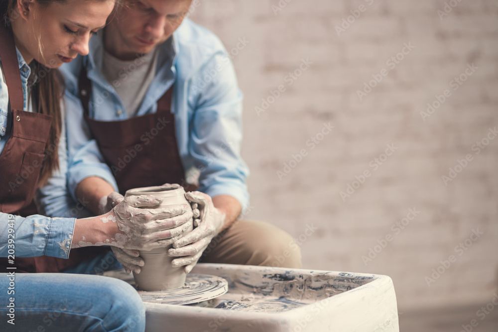 Young couple at the potters wheel