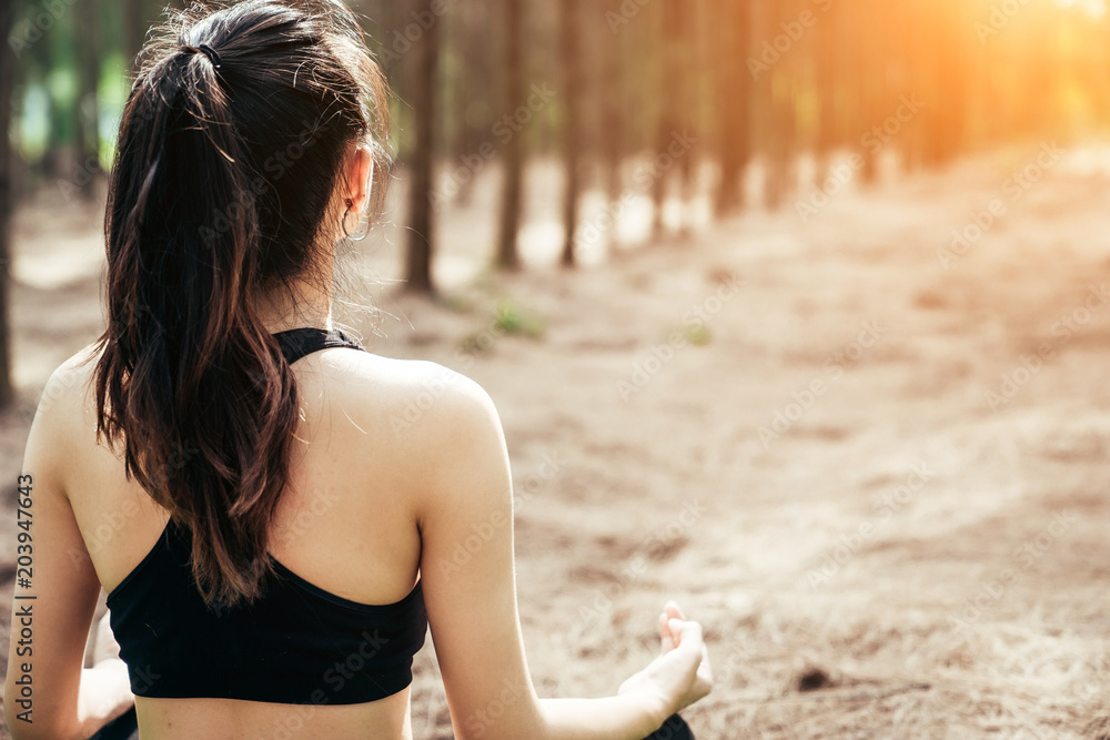 Asian girl is exercising at the weekend in a pine forest green and lush beautiful. Sport girl and li