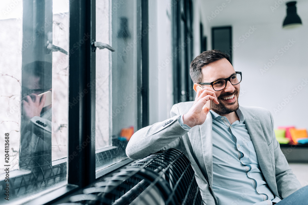 Portrait of a successful businessman talking on a smartphone.