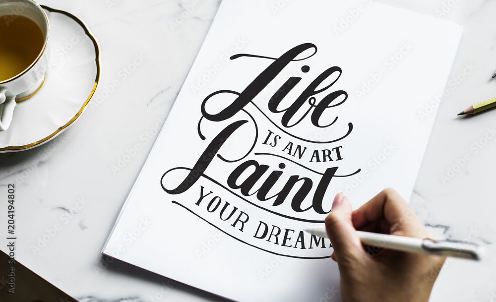 An artist creating hand lettering artwork