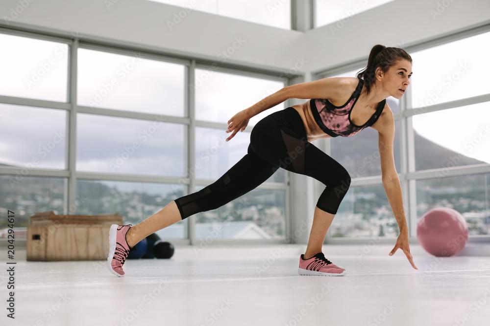 Female doing stretching workout in health center