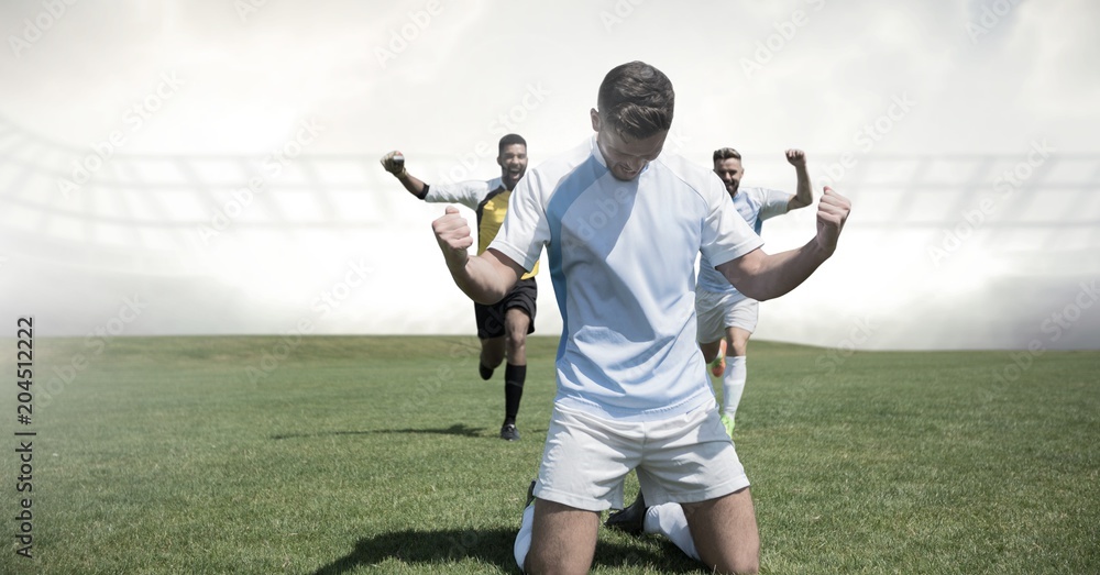 Soccer players celebrating on grass