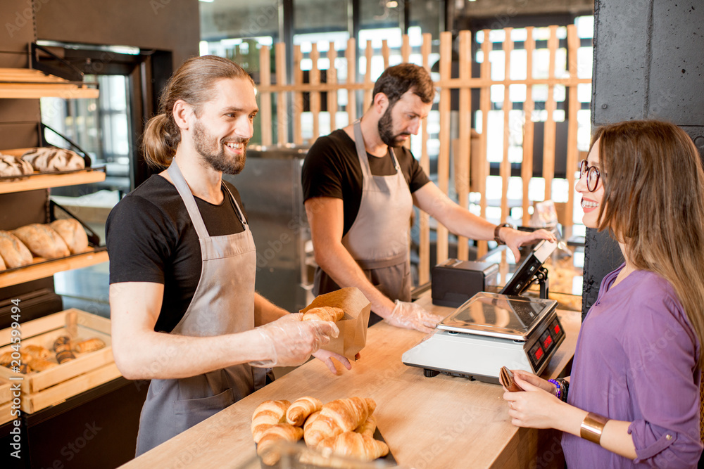 Bread sellers with client at the bakery shop