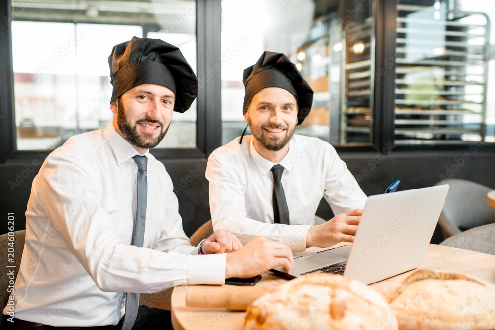 Bakers working with laptop in the office