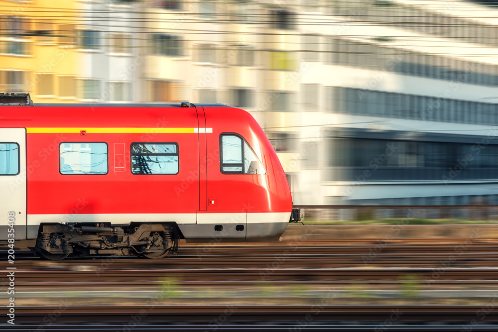 High speed train in motion on the railway station at sunset in Germany. Modern intercity train on th