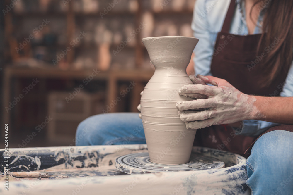 Young couple working on a potters wheel