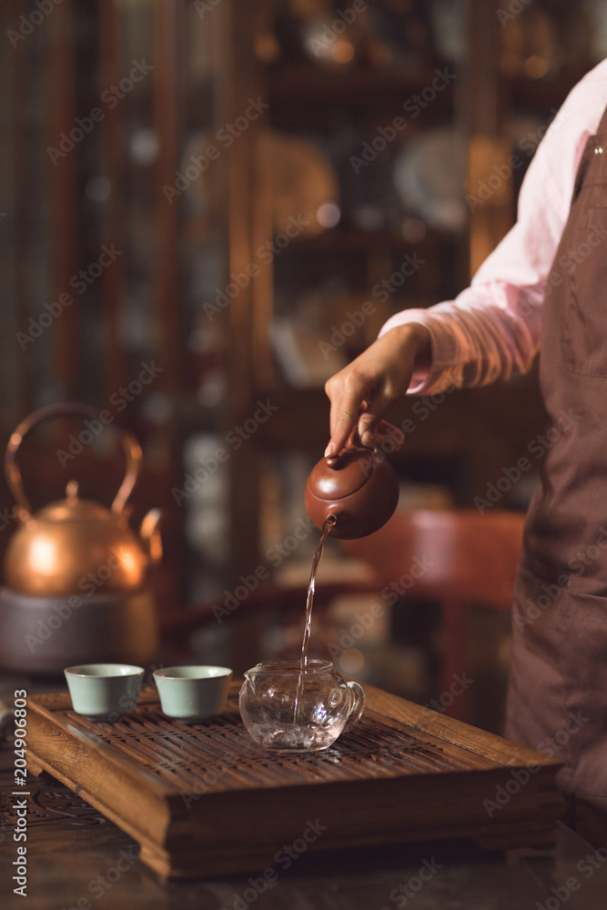 Tea master pouring tea indoors