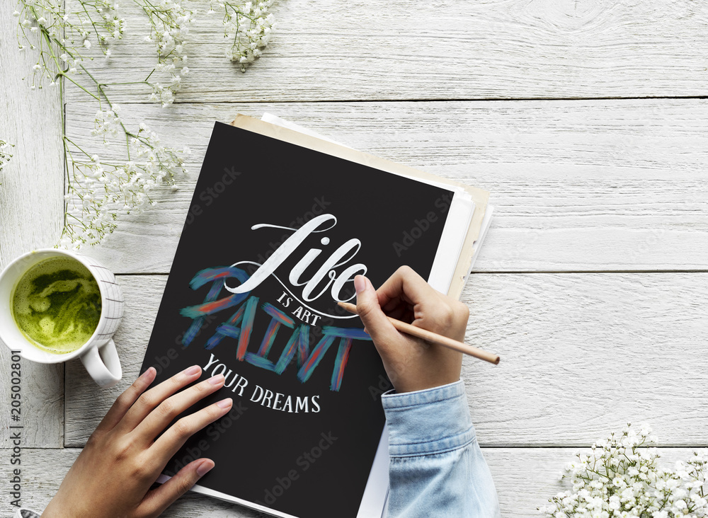 An artist creating hand lettering artwork from motivation quote