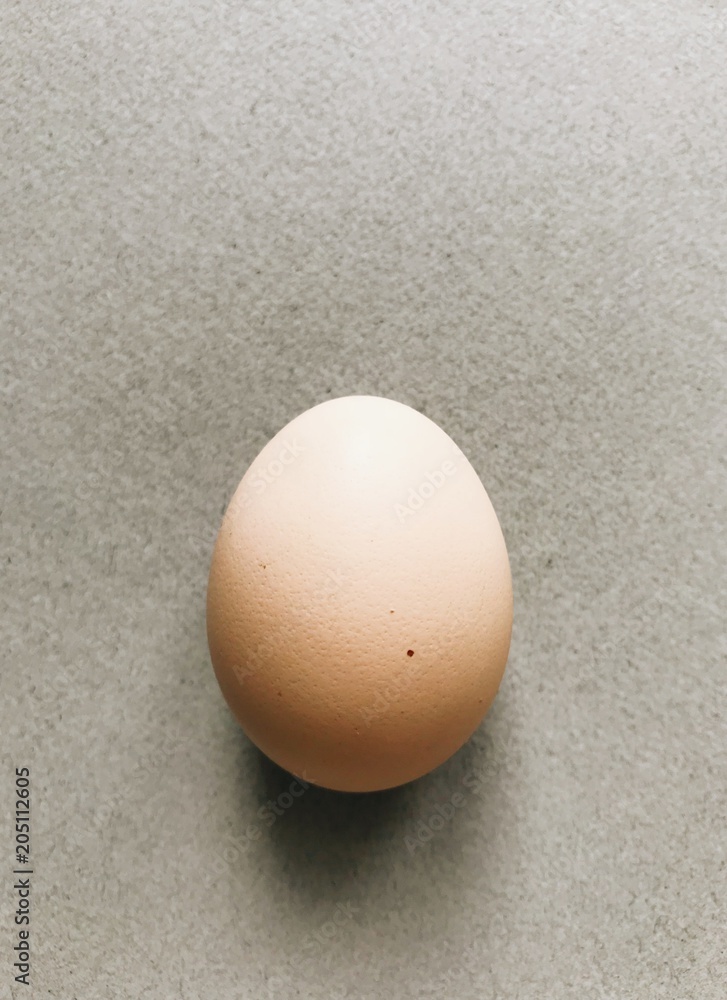 Chicken homemade egg on a gray background. 