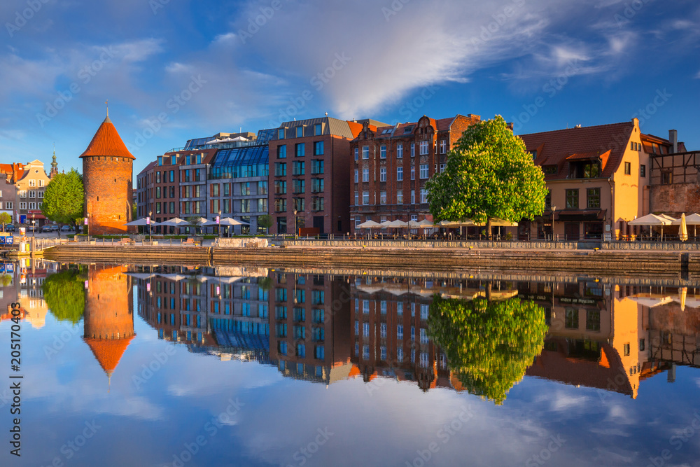 Beautiful old town of Gdansk reflected in Motlawa river at sunrise, Poland.