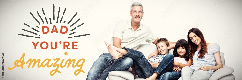 Composite image of family sitting on sofa smiling at camera 