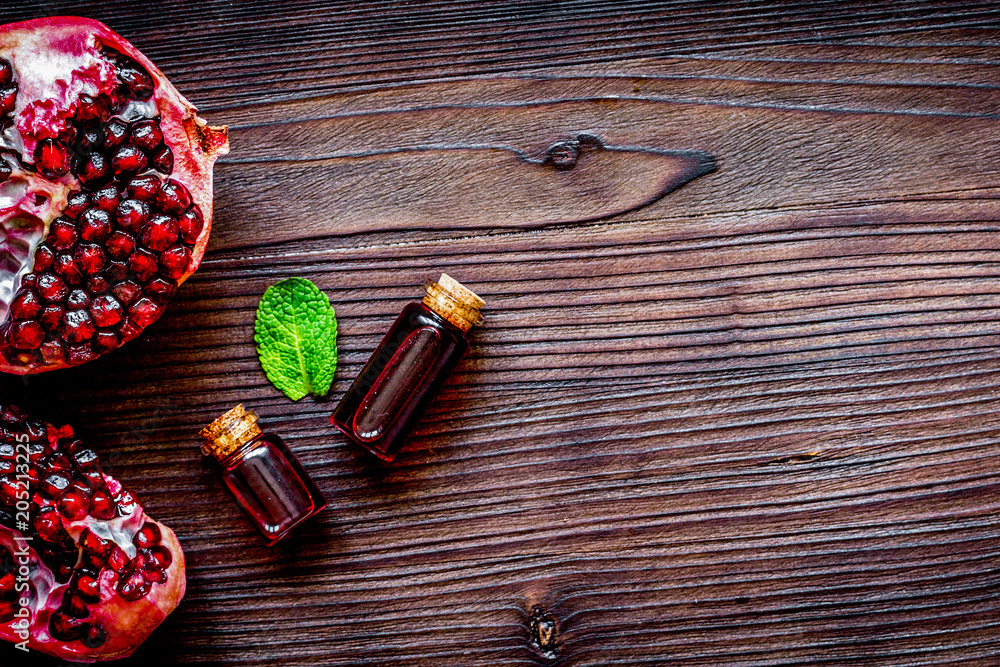 sliced pomegranate on wooden background top view