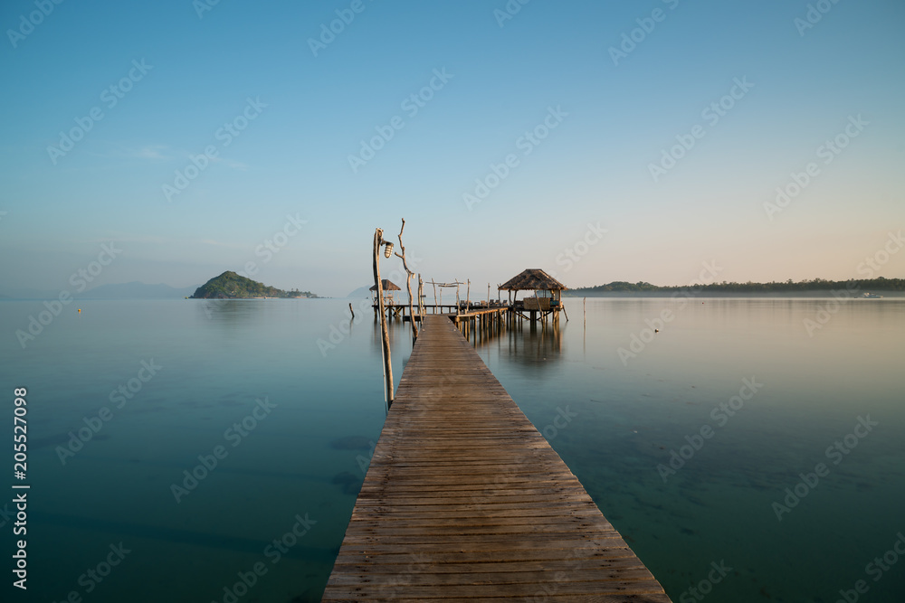 Wooden pier between sunset in Phuket, Thailand. Summer, Travel, Vacation and Holiday concept.