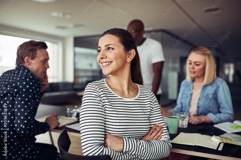 微笑的年轻女商人在办公室里回头看