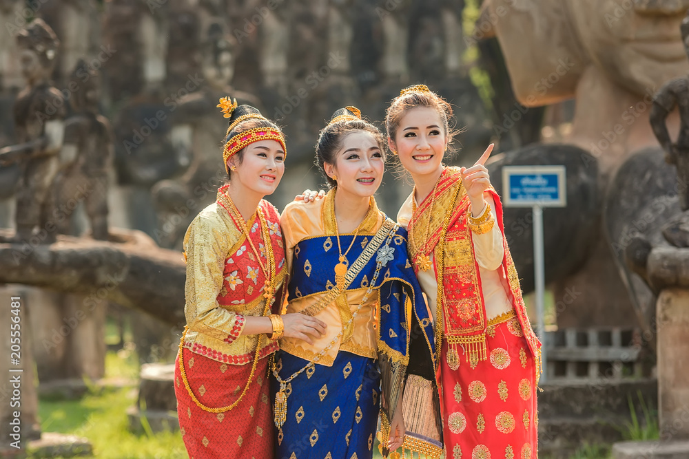 Beautiful girl in Laos costume,Asian woman wearing traditional Laos culture at temple.Vintage style.