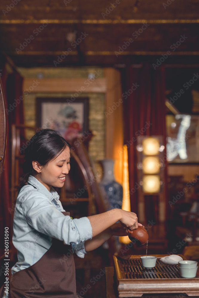 Young tea master in the room