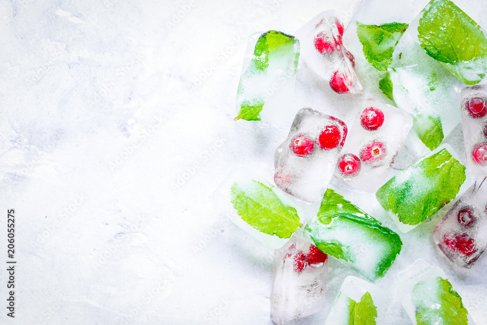 fresh cranberry in ice cubes on gray stone background top view m