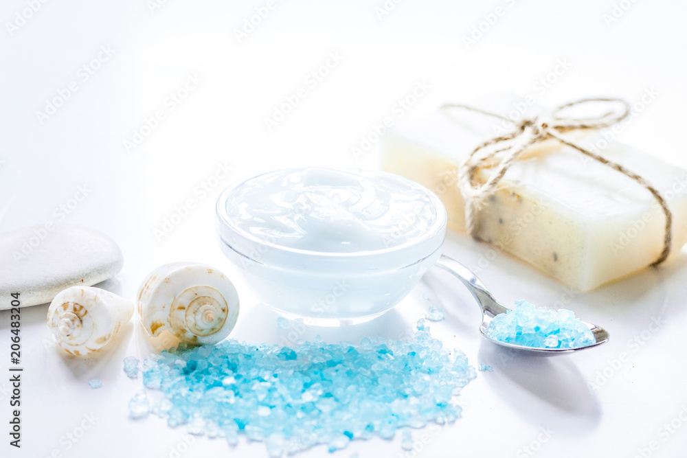 spa composition with blue sea salt and natural soap on white des