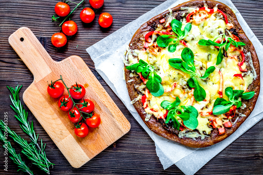 cooking pizza with vegetables and cheese on wooden desk backgrou