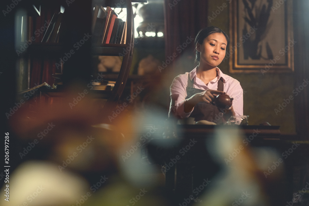 Young asian girl with a teapot