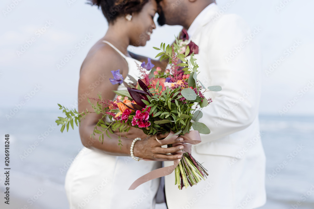 African American couple getting married at the beach