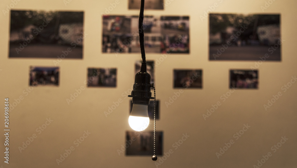 A bright light bulb hanging in a room