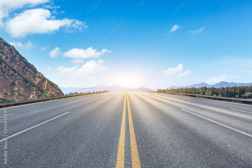 Empty asphalt road and hills with sky clouds landscape