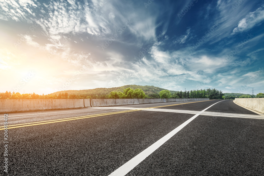 Asphalt road and mountain with sky clouds landscape at sunset