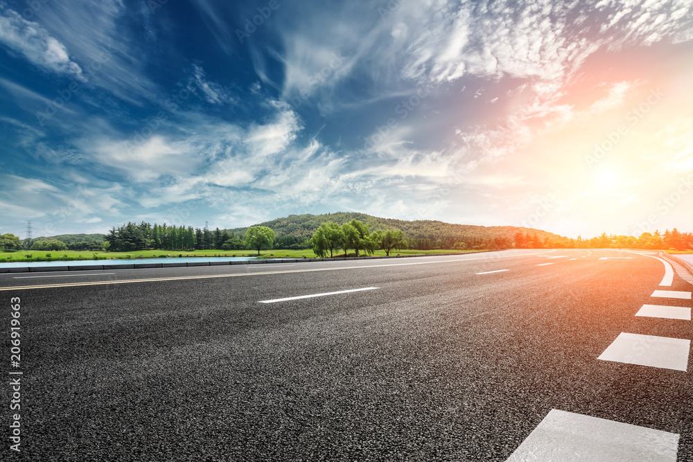 Asphalt road and mountain with sky clouds landscape at sunset