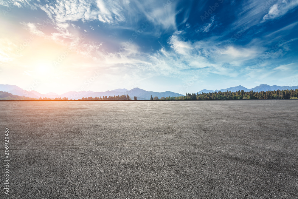 Asphalt square road and hills with sky clouds landscape at sunset