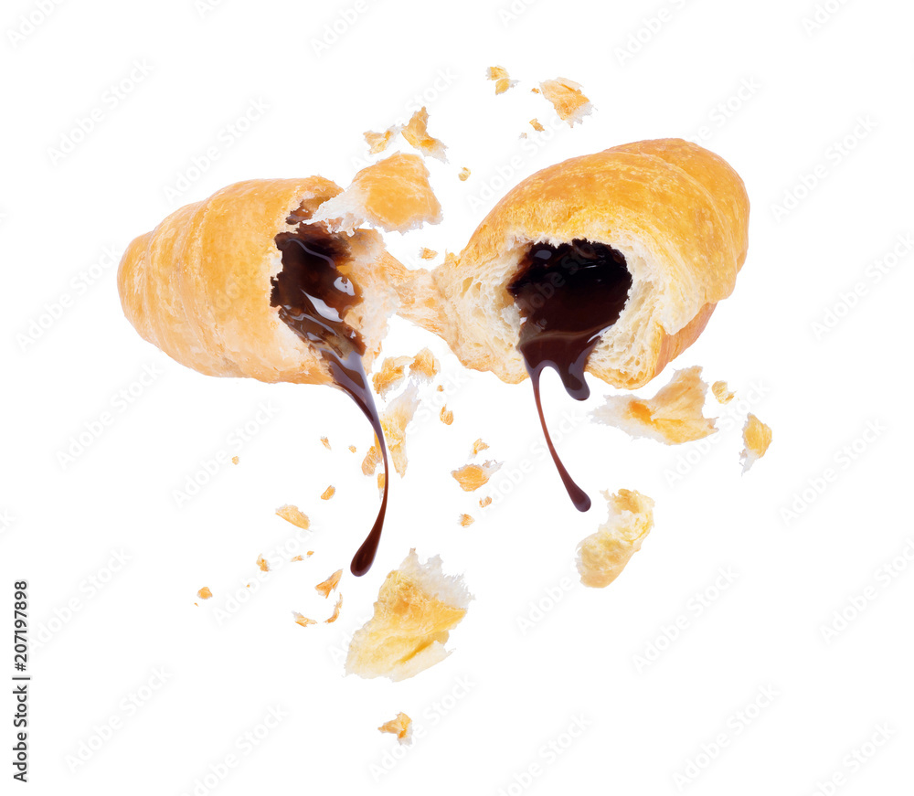 Chocolate flowing from two halves of a croissant close-up