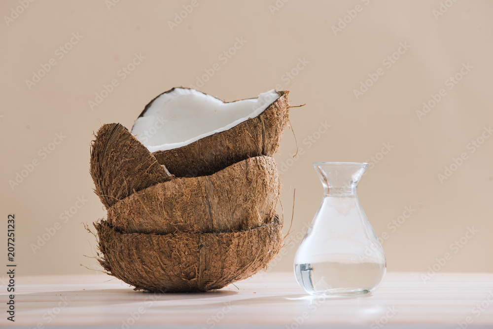 Healthy skincare. Pure coconut oil is made from organic coconut on wooden background