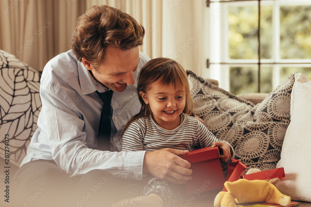 Father and daughter opening a gift box