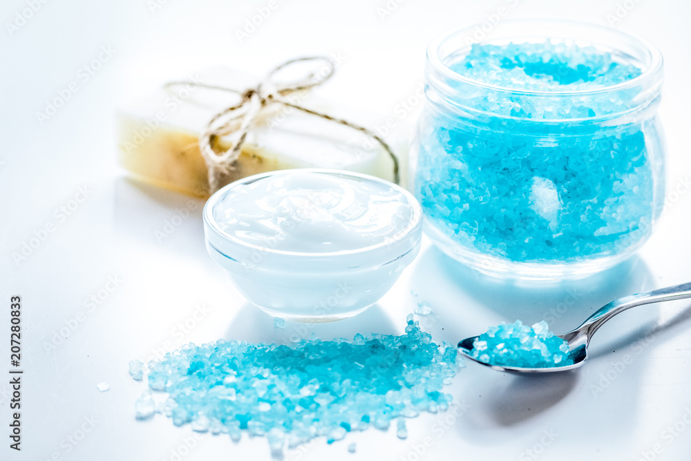 blue sea salt, soap and body cream on white desk background