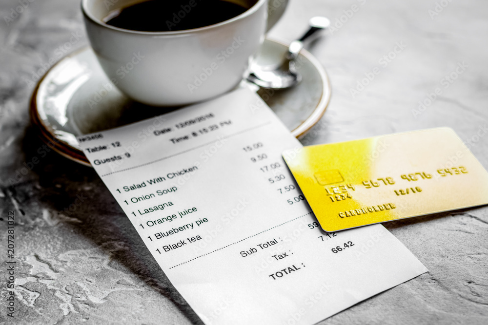 coffee and receipt bill for payment by credit card on stone tabl