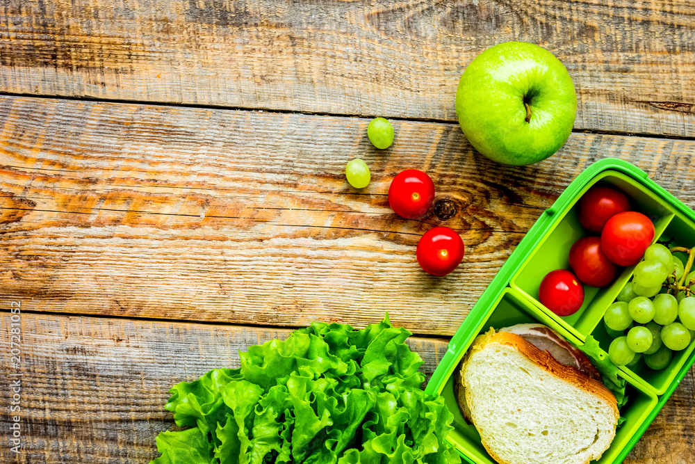 take away with lunchbox and fresh food on wooden background top 