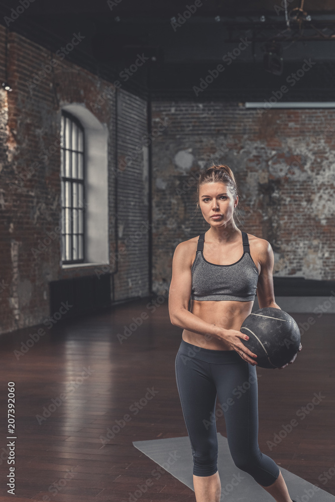 Young sporty girl with a ball