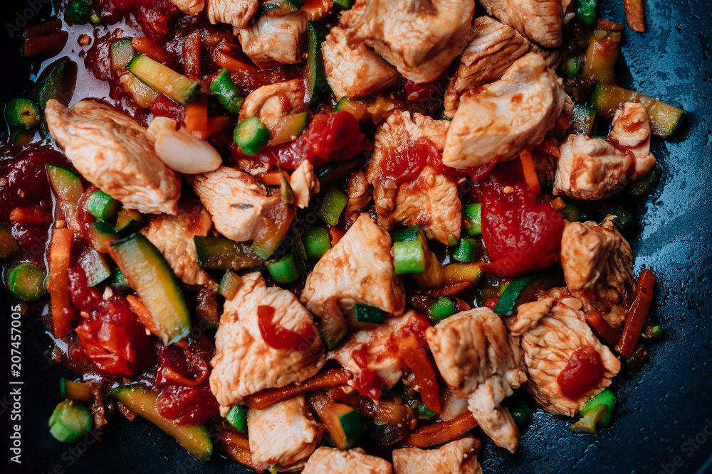 Pork Goulash with a lot of vegetables like tomatoes, asparagus, Capsicum annuum , Zucchini and onion