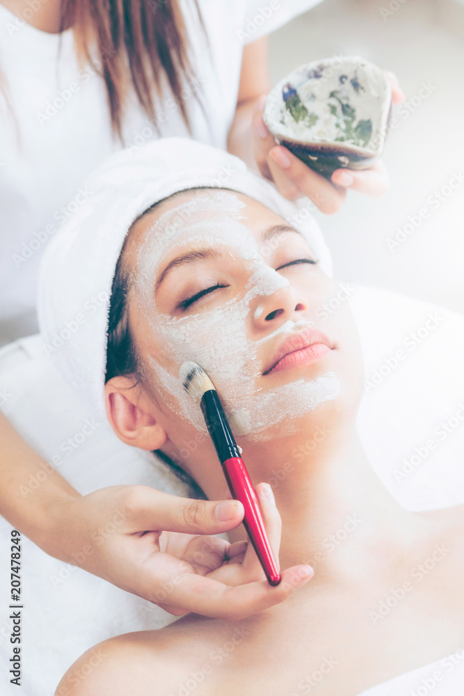 Beautiful woman having a facial treatment at spa.