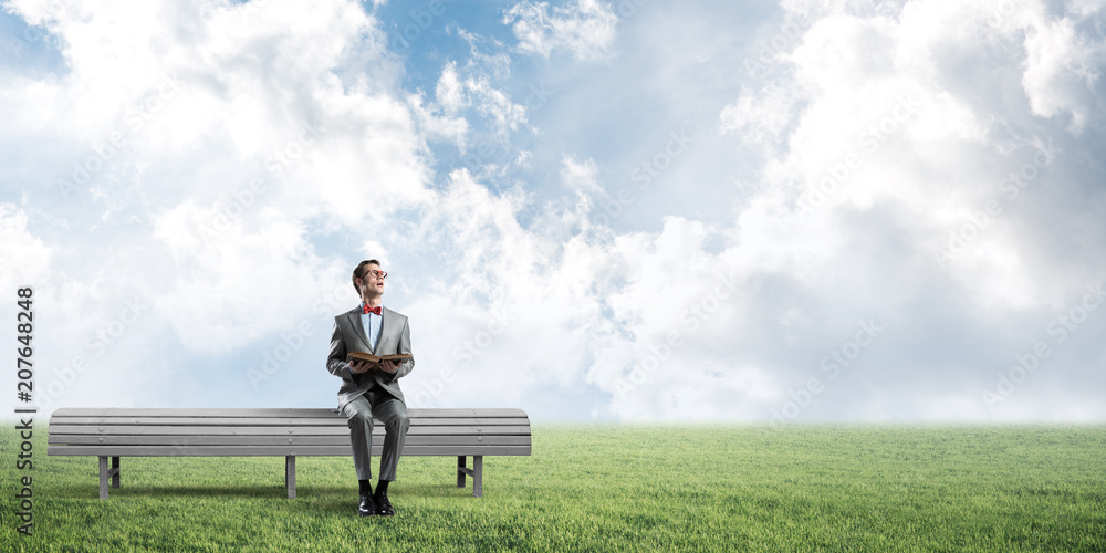 Young businessman or student studying the science in summer park