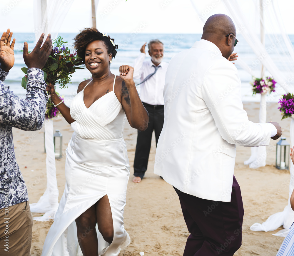 African American couple getting married at the beach