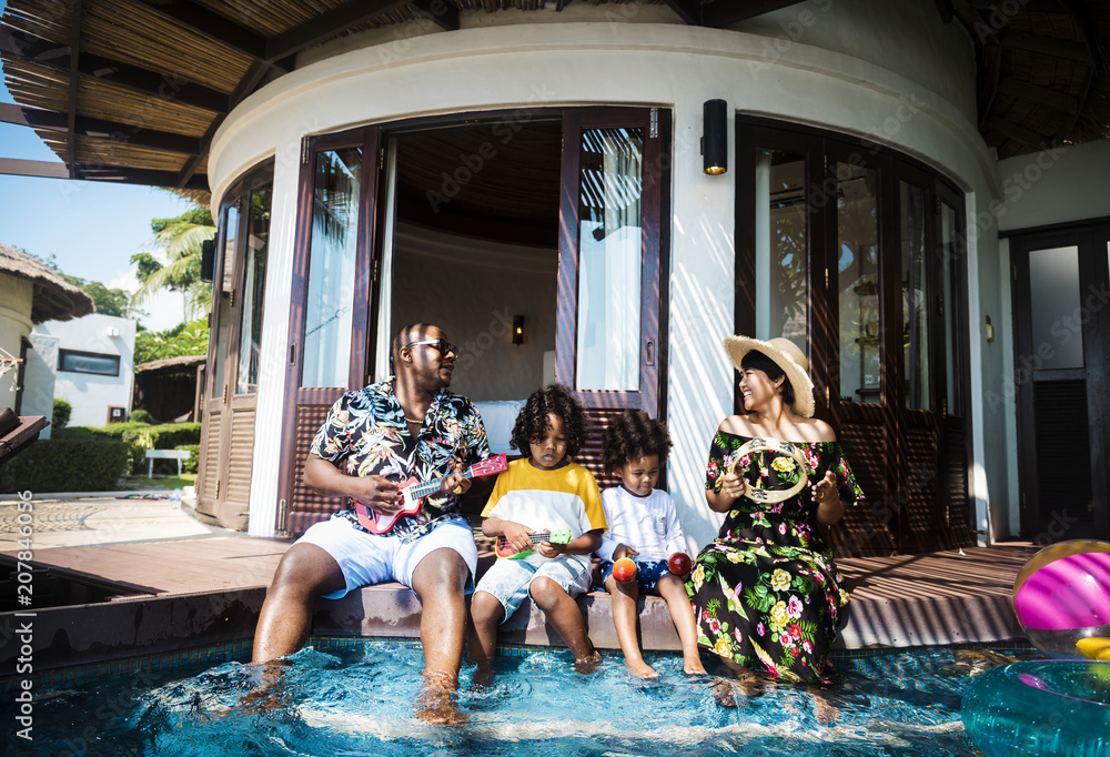 Family playing in a pool