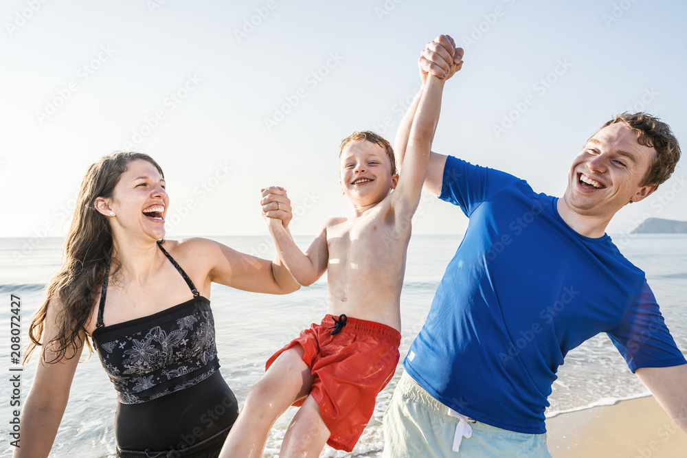 Family playing on the beach