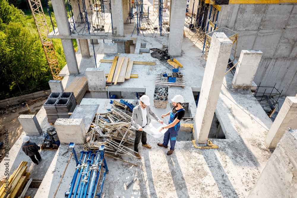 Top view on the construction site of residential buildings during the construction process with two 