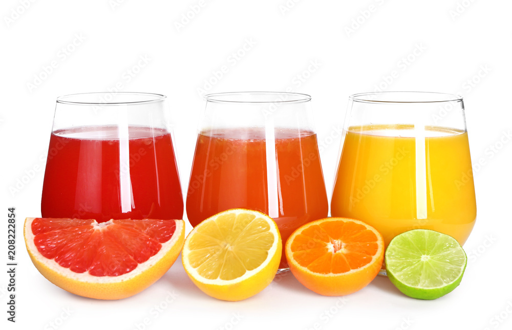 Glasses with delicious citrus juice and fresh fruits on white background