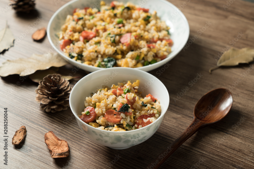 Fried rice with egg and wood grain background