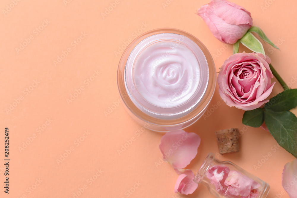 Beautiful composition with body cream and flowers on color background