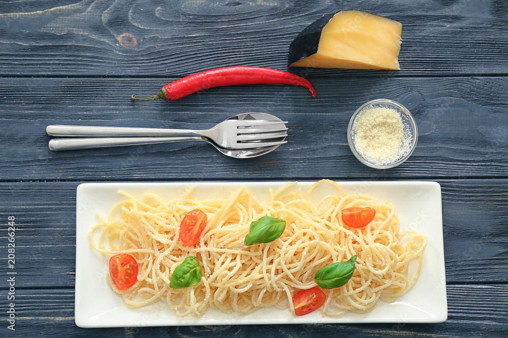 Plate with spaghetti and tomatoes on table. Delicious pasta recipes