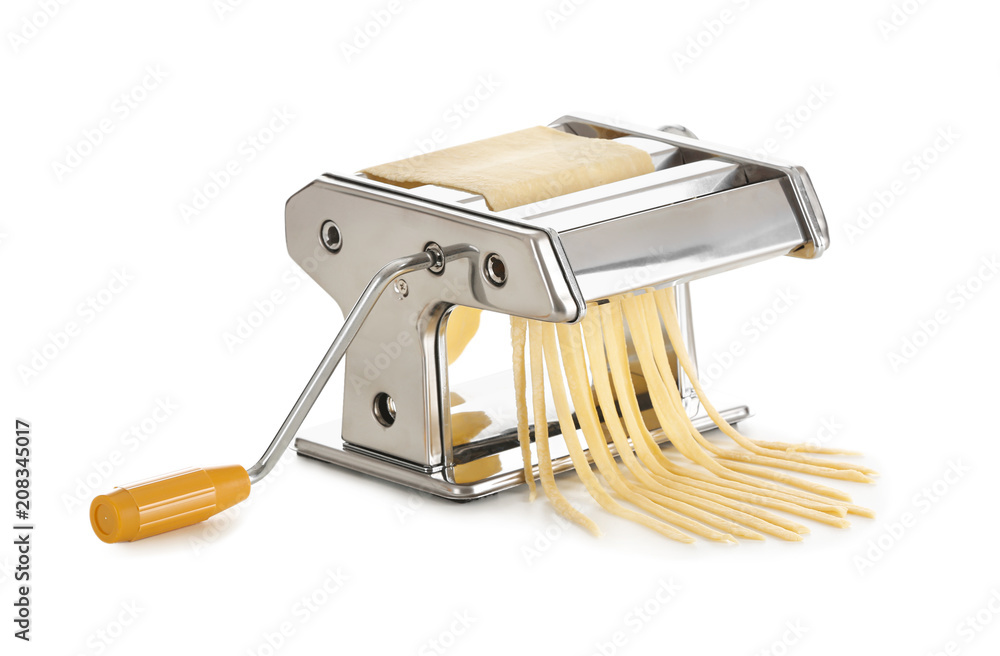 Metal pasta machine with dough on white background