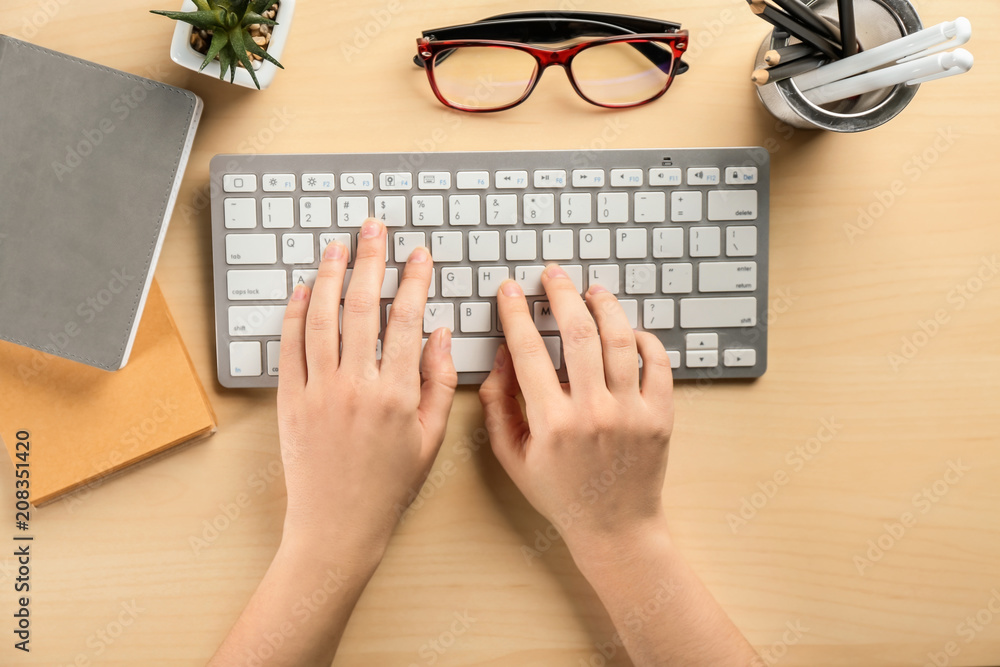 Woman using computer at table, flat lay. Workplace composition